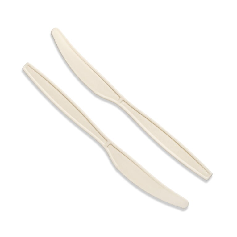 Two natural cornstarch compostable knives on a white background