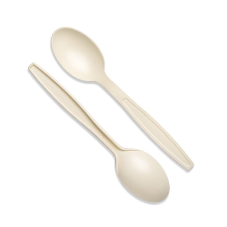 Two natural-colored cornstarch dessert spoons on a white background