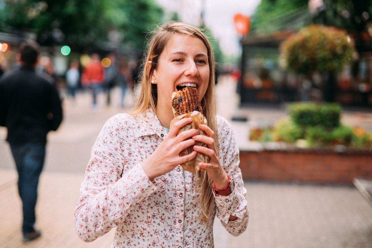 Woman eating wrap in eco friendly packaging