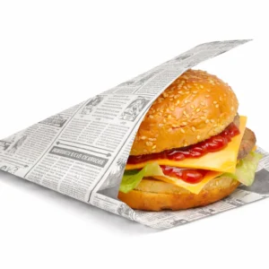 Cheeseburger in an open-sided newspaper-print takeaway bag