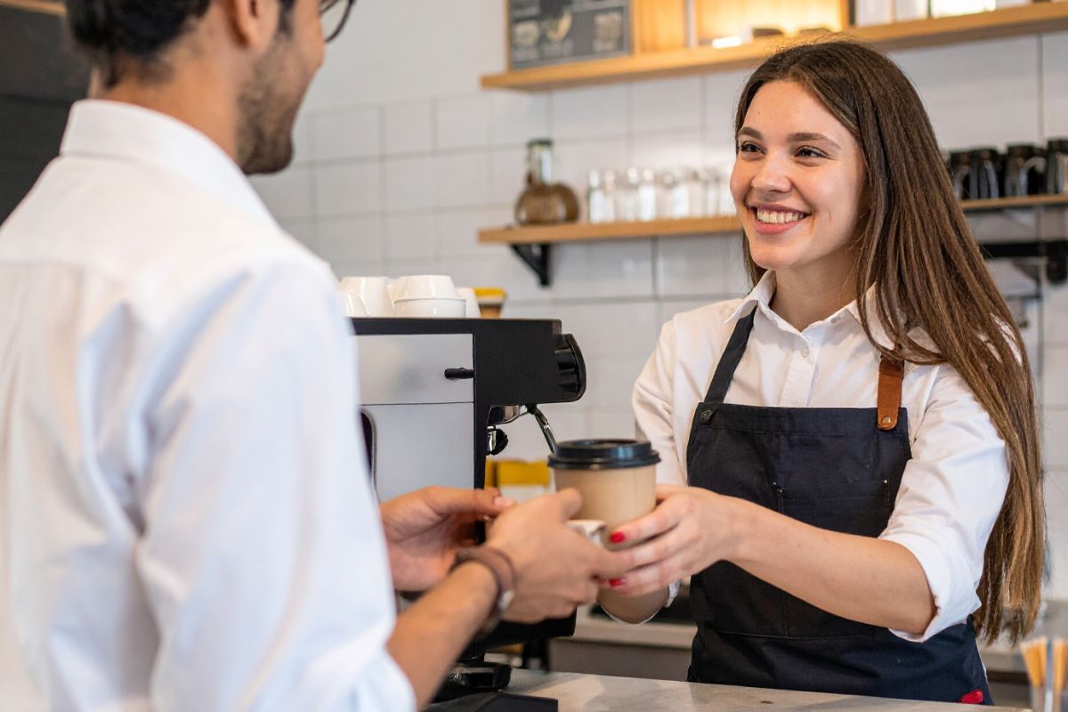 Hot drink being served at café in eco cup