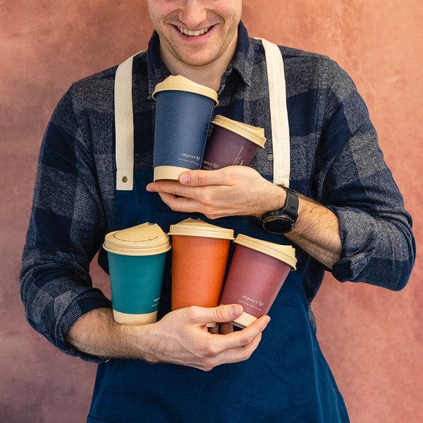 Business owner carrying Vegware Feel Snug cups